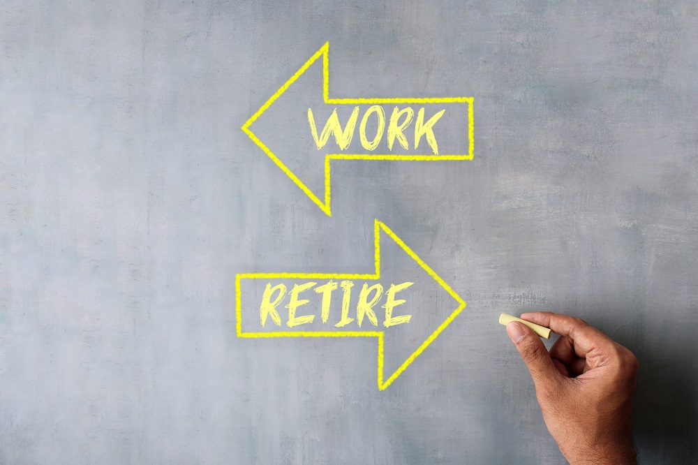 Hand draw arrow with text WORK and RETIRE using chalk. Work vs retire. Retirement: Discover if an employee's contract automatically end at legal age?Payroll Belgium